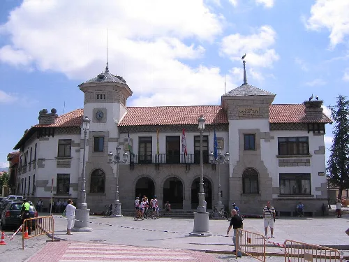 Town hall building with towers and flags on the facade.