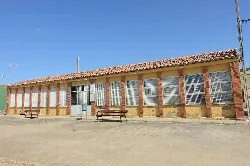 School building with large windows and tiled roof in La Unión de Campos.