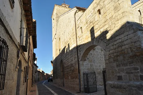 Narrow streets with a stone church on the corner.