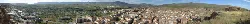Panoramic view of Arnedo from the castle, with buildings and mountains in the background.