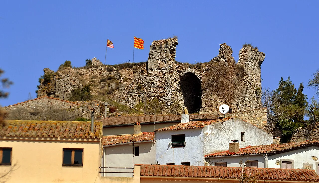 Stone castle with towers and flags in Querol, Tarragona.