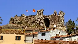 Stone castle with towers and flags in Querol, Tarragona.