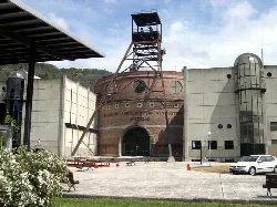 Museum building with a mining tower and arched entrance.