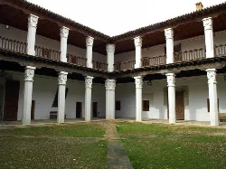 View of the interior courtyard with white columns and balcony.