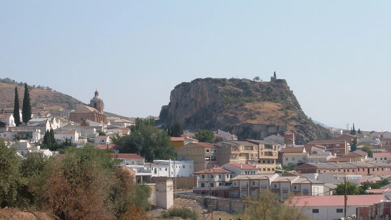Houses and a castle on a hill in Íllora, Granada.