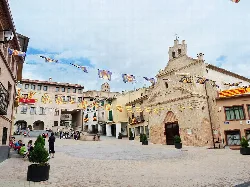 Magallón square with the 18th-century hermitage and decorative banners.
