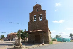 Cristo chapel in La Unión de Campos, with brick bell tower and cross on top.