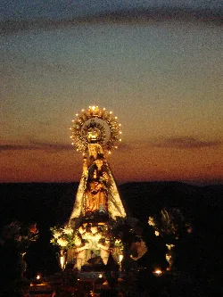 Virgin of Nava procession with candles at sunset in Fuentelcésped.