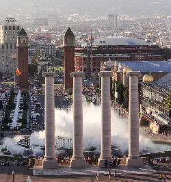 Six columns in the foreground with the fountain and Barcelona city behind