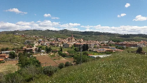Panoramic view of Ateca with houses, hills, and a cloudy sky.