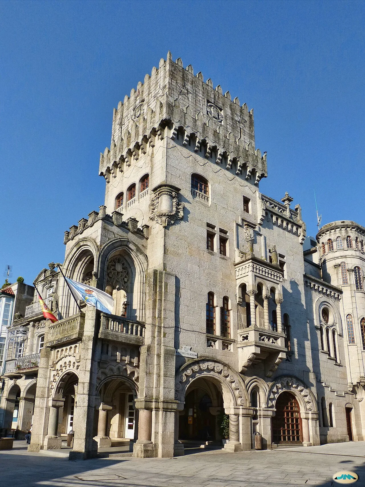 Stone building with tower and arched windows in Porriño.