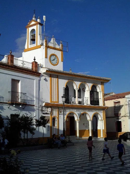 Town hall building with clock and bell tower in Aznalcázar, Seville.
