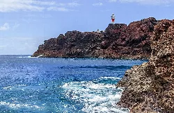 Lighthouses at Punta de Teno with red cliffs and blue sea.