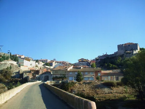 Ancient bridge and houses on a hill in Palenzuela.