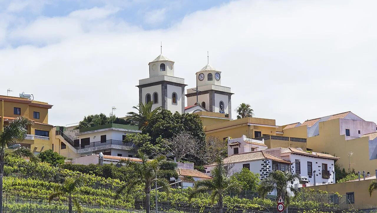 San Salvador church on a hill with colorful houses around.