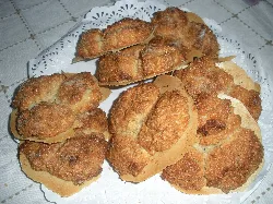 Almond sweets on a tray with tissue paper.
