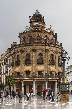 Round building with signs and a clock in Jerez de la Frontera square.