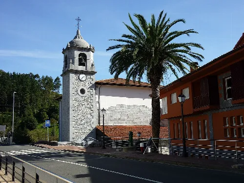 Iglesia con torre y palmera en Gizaburuaga, Vizcaya.