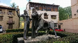Sculpture of a clown and a bull in a square in Rubielos de Mora.