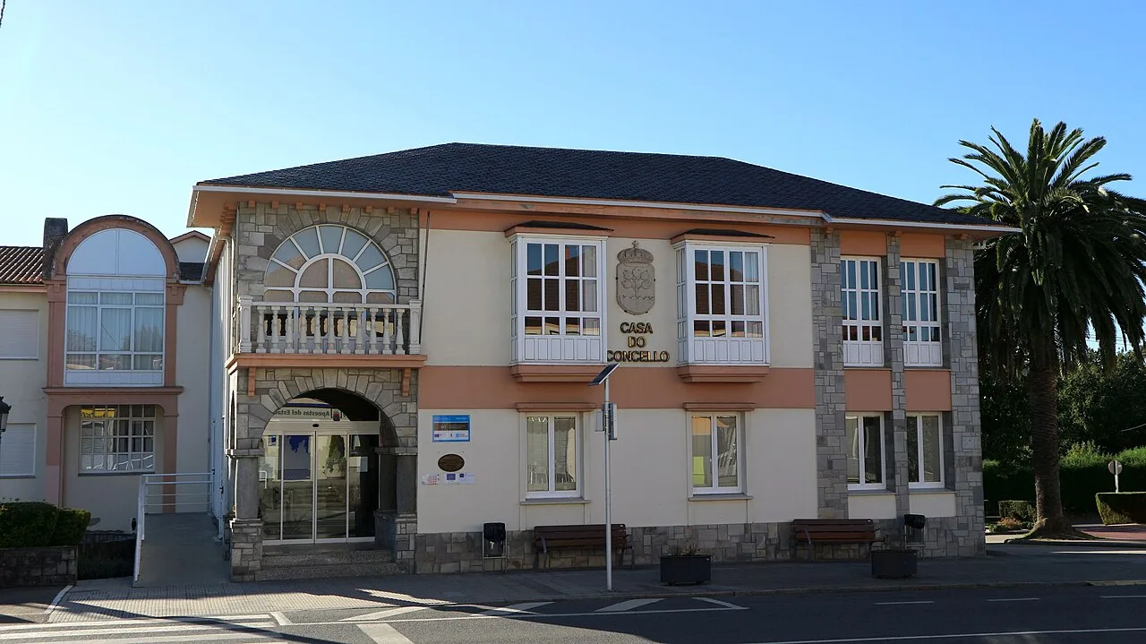 Town hall building with modern facade and palm tree in Abegondo.