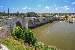 Stone bridge with arches over the Duero River in Tordesillas.