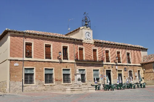 Edificio de dos plantas con reloj y campanario en la plaza de Mota del Marqués.