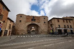 City gate with stone arch in Lerma.
