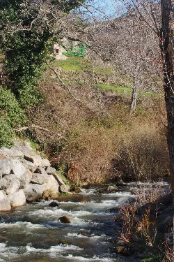 Corneja River with trees and rocks in La Ribera, Villafranca de la Sierra.