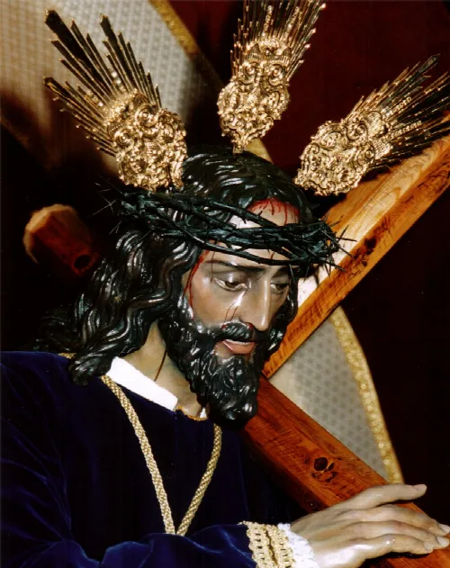 Statue of Jesus the Nazarene with crown of thorns and wooden cross.
