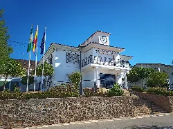 Town hall of Villaharta with flags and clock in Córdoba, Spain.