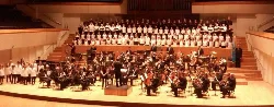Orchestra and choir on a stage in the auditorium.