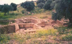 Ruins of a Roman villa with stone walls and ancient structures.