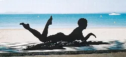 Gigantic ice sculpture on Roses beach, shaped like a lying child playing.