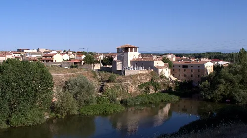 View of the town with church and river in the foreground.