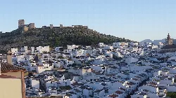 View of white houses and hilltop castle in Teba.