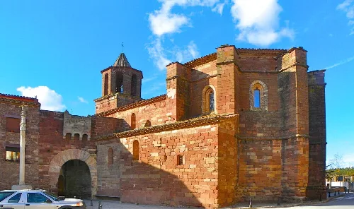 Red stone church and portal in Prades, Tarragona.