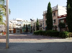 Main square of Picassent with buildings and trees.
