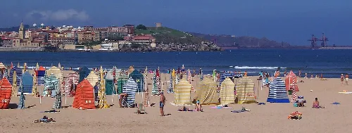Strand von San Lorenzo mit Sonnenschirmen und Touristen.
