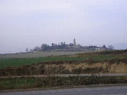 Church on a hill with fields and trees around.