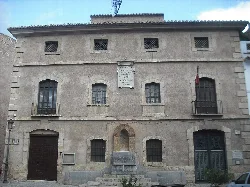 Stone building with barred windows in Segorbe.