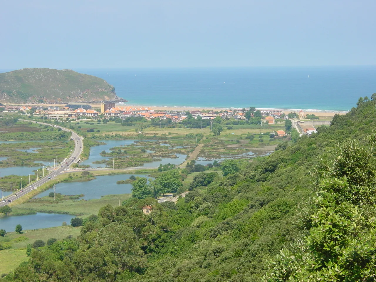 Marshlands, beach, and green hills in Santoña, Cantabria.