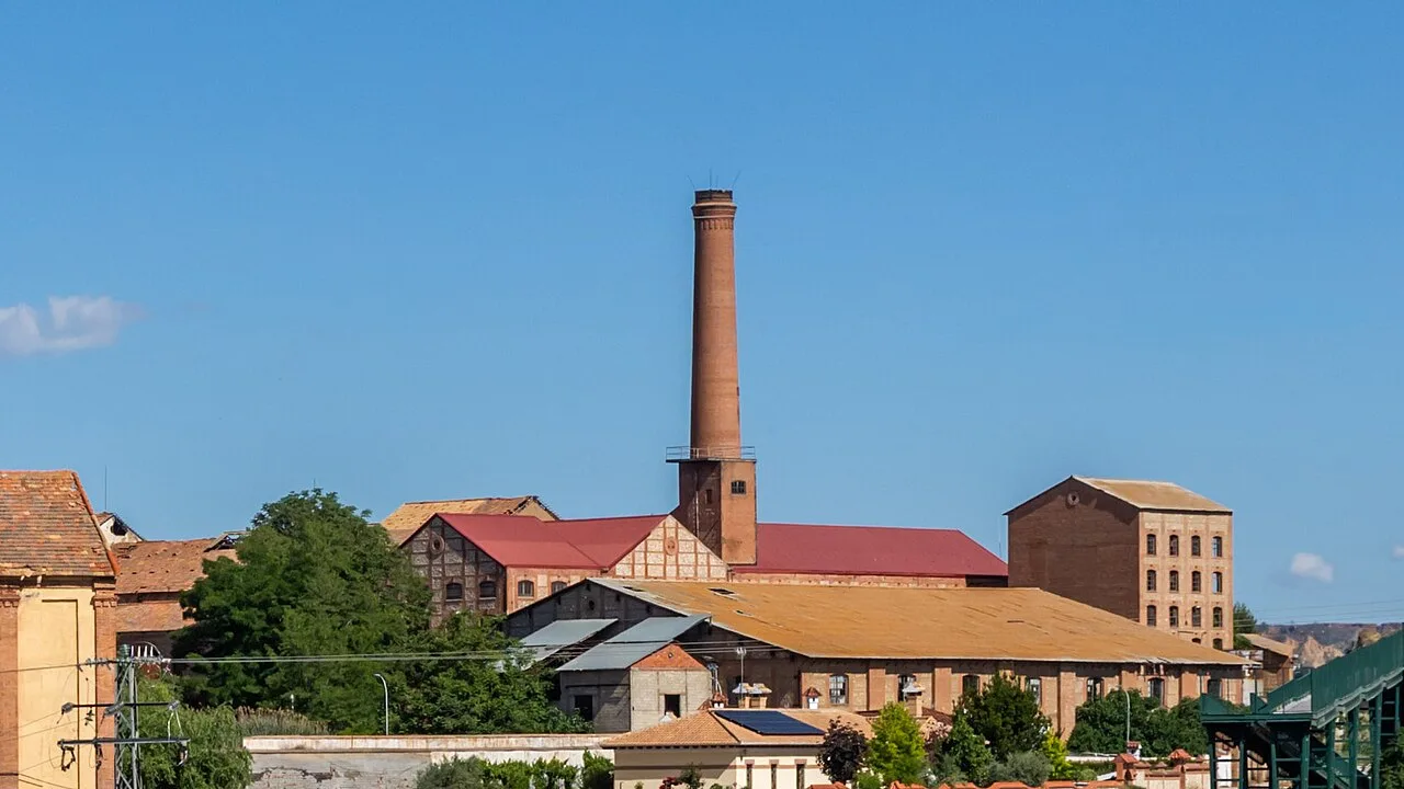 Traditional buildings and an industrial chimney in Benalúa, Granada.