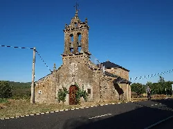 Hermitage of Santo Cristo with bell tower and stone facade in Rosinos de la Requejada.