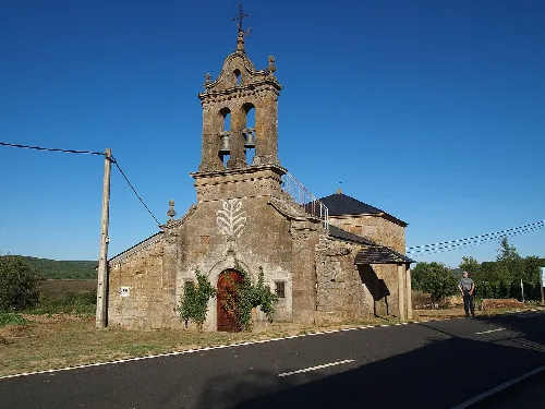 Hermitage of Santo Cristo with bell tower and stone facade in Rosinos de la Requejada.