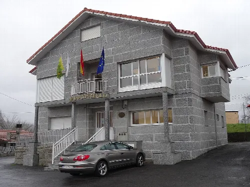 Town hall with flags on the facade.