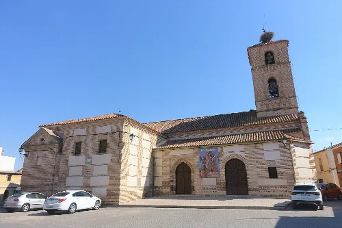 San Miguel Arcángel church with tower and stone facade in El Carpio de Tajo.