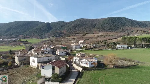 Aerial view of houses and mountains in Echarri-Etxarri.