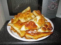 Carnival ears sweets on a plate on a countertop.