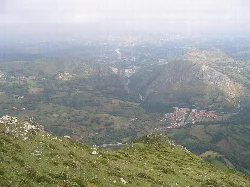 Panoramic view of Morcín from Monsacro with mountains and valley.