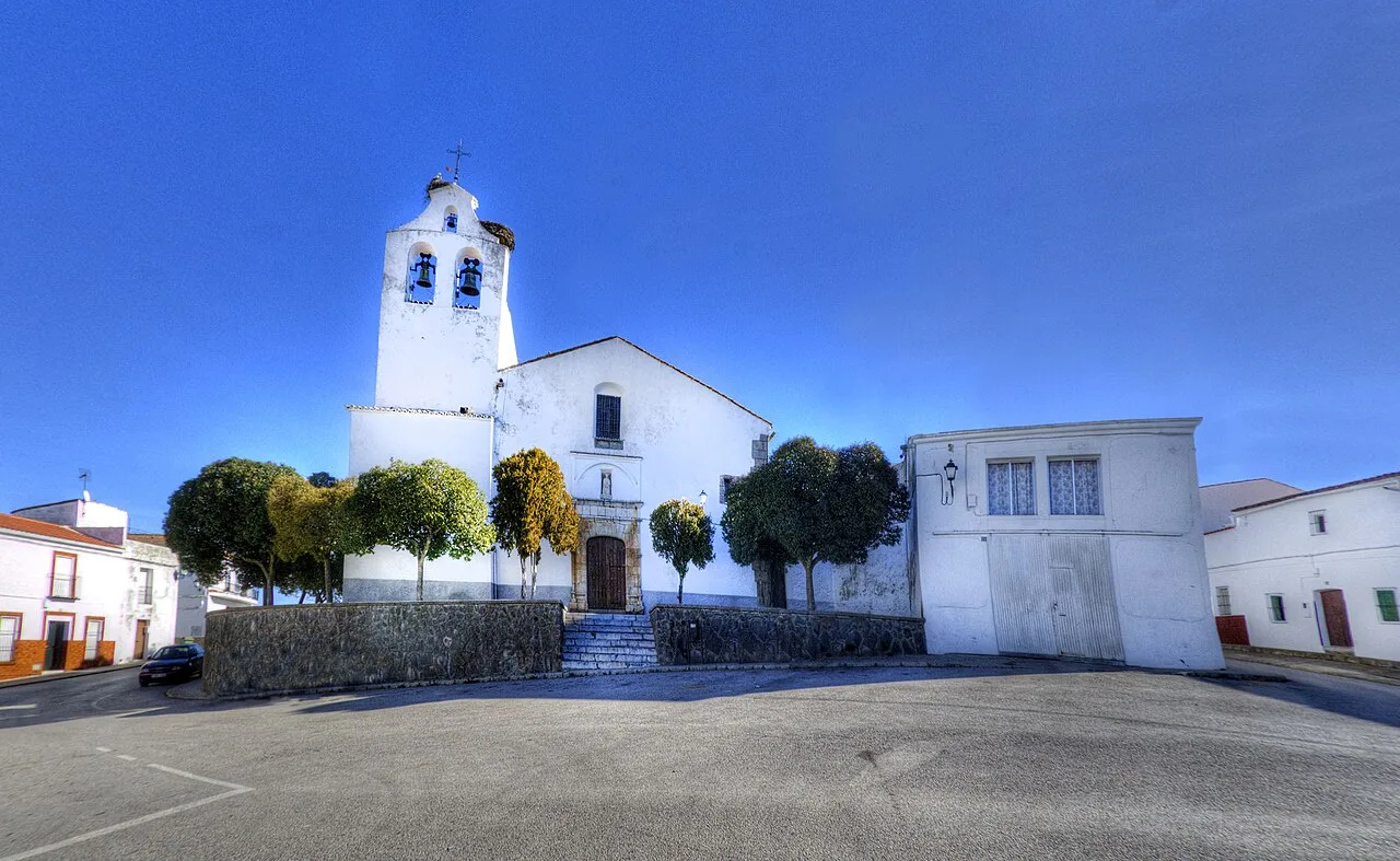 Plaza con iglesia blanca y árboles en Usagre, Badajoz.